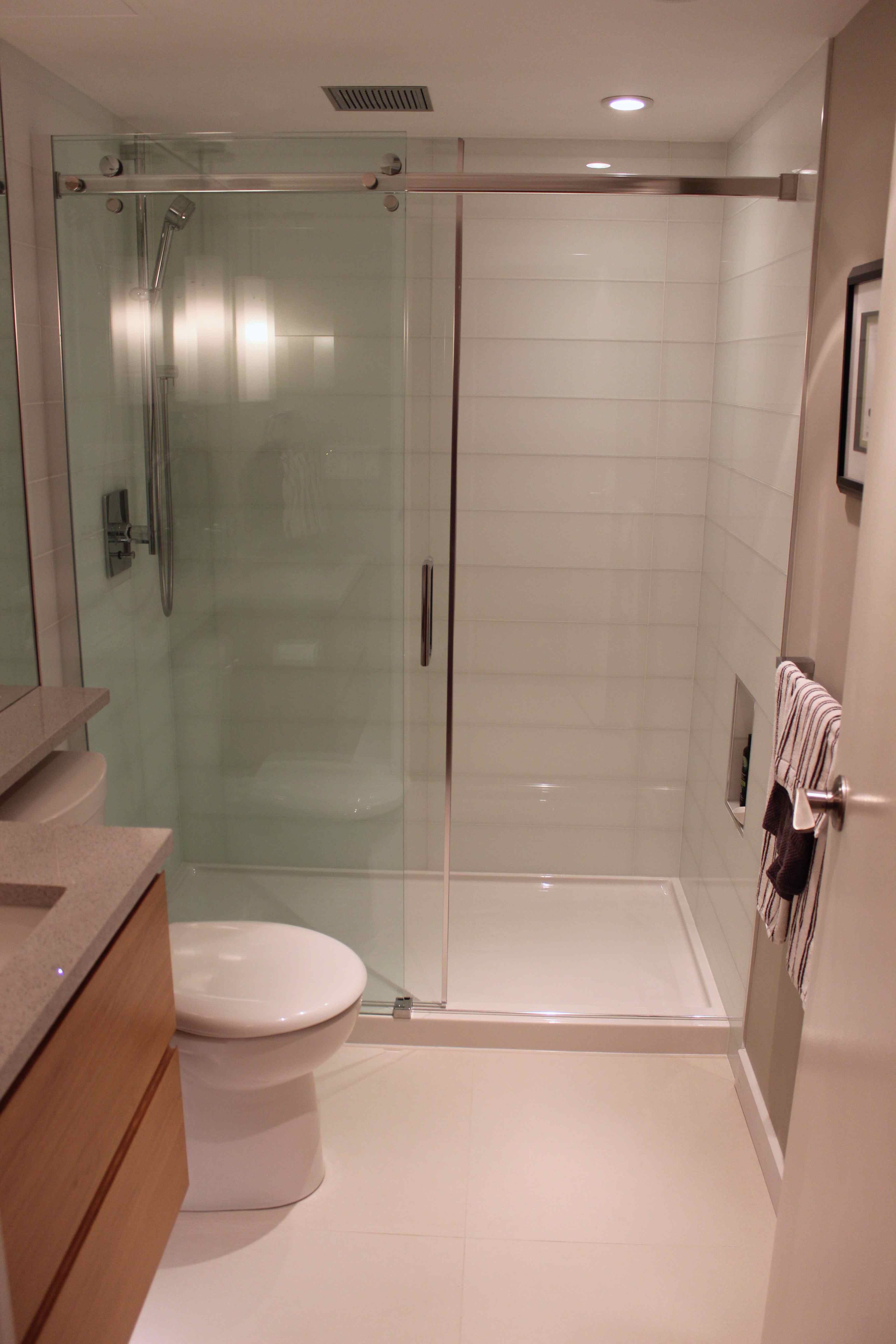 Condo Bathroom Shower with Glass Door and Glass Tile